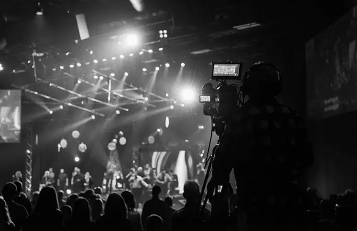 Concert lighting design by Flow Productions illuminating a packed venue