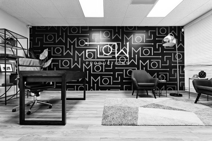 Flow Productions podcast studio with branded acoustic wall